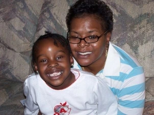 Grandmother and granddaughter smiling together