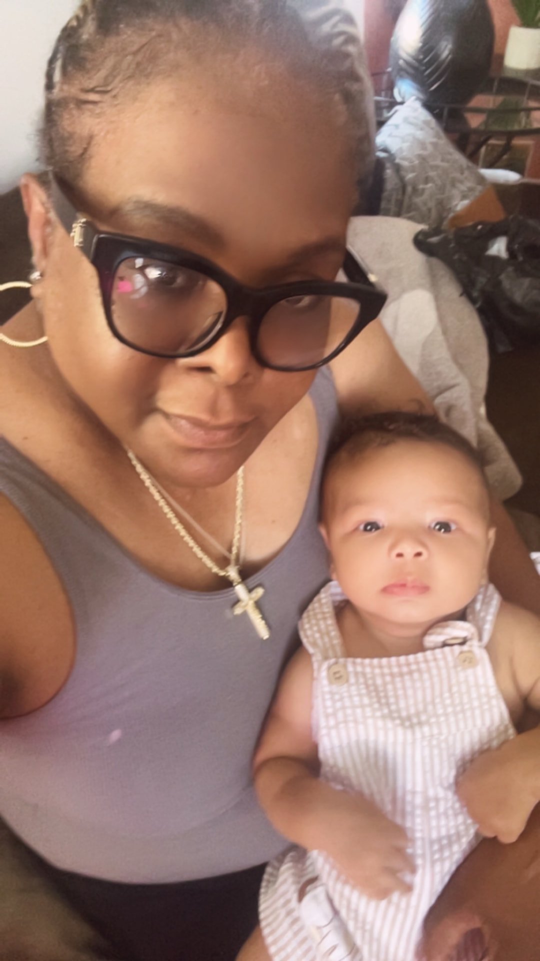 Chinique holding a newborn baby she cares for in Charleston